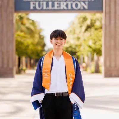Marl Kristoffer Rico, founder of MKR Tech Services, in graduation regalia at California State University, Fullerton